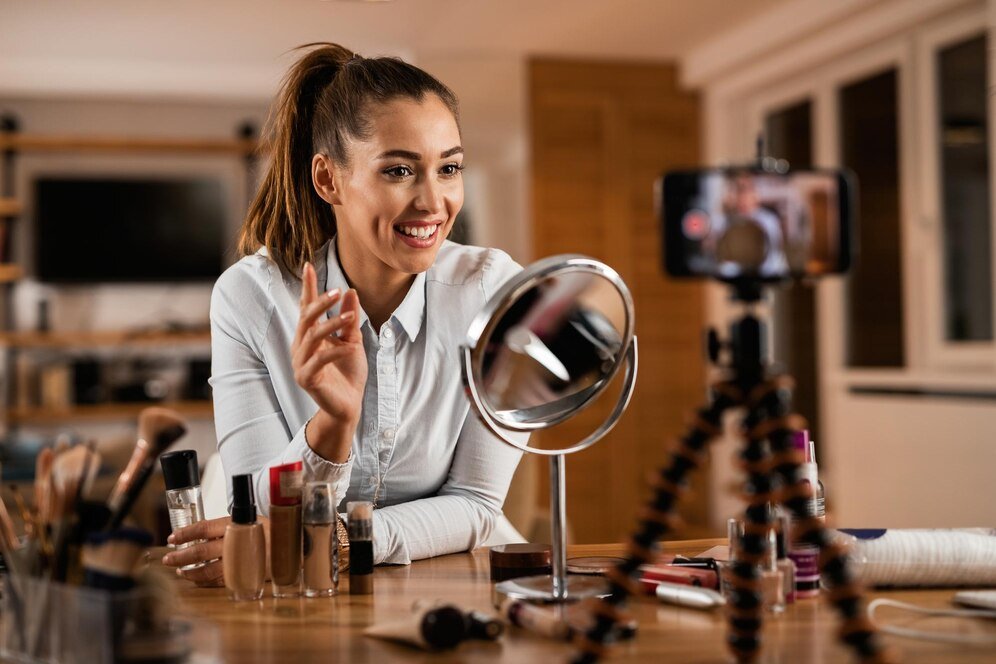 smiling-female-influencer-talking-about-beauty-products-while-vlogging-from-home_637285-4353