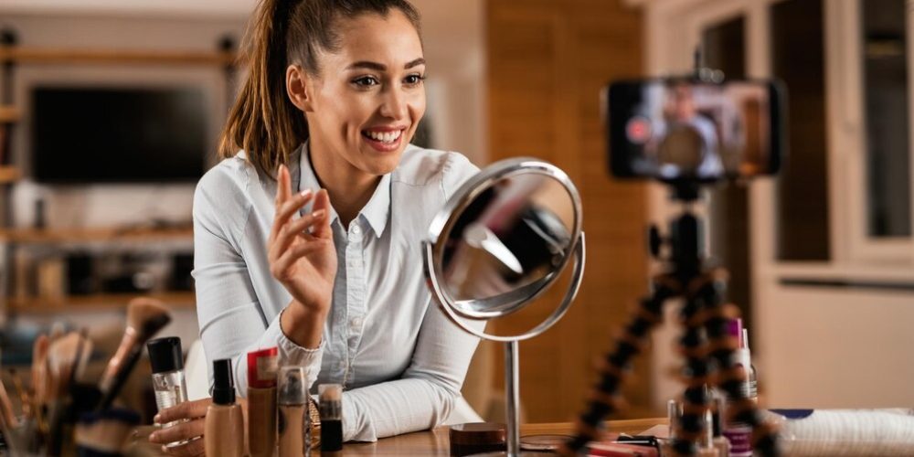 smiling-female-influencer-talking-about-beauty-products-while-vlogging-from-home_637285-4353 smiling-female-influencer-talking-about-beauty-products-while-vlogging-from-home_637285-4353